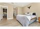 Spacious bedroom with ensuite bathroom, laundry room access, neutral decor, and wood-look floors at 15061 W 70Th Ave, Arvada, CO 80007