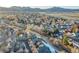 An aerial view of the property showcases its location within a lush residential neighborhood and mountain views at 11803 W Stanford Dr, Morrison, CO 80465