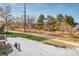 Backyard with patio set, mature trees, and distant views of the neighborhood at 11803 W Stanford Dr, Morrison, CO 80465