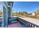 Outdoor balcony showcases a table set with a view of the surrounding landscape at 11803 W Stanford Dr, Morrison, CO 80465