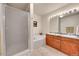 Bright bathroom featuring a large, tiled tub, step-in shower, double-sink vanity and large mirror at 11803 W Stanford Dr, Morrison, CO 80465