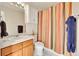 Neat bathroom featuring a vanity with storage and a shower with a colorful curtain at 11803 W Stanford Dr, Morrison, CO 80465