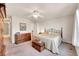 Spacious bedroom includes a ceiling fan, natural light, and wood furniture at 11803 W Stanford Dr, Morrison, CO 80465