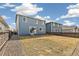 Backyard with gravel landscaping and a small patch of grass, enclosed by a wooden fence at 26857 E Maple Ave, Aurora, CO 80018