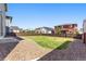 A spacious fenced backyard featuring gravel and grass areas, providing a versatile outdoor space at 26857 E Maple Ave, Aurora, CO 80018