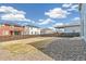 Large backyard with gravel and dry grass areas surrounded by a wooden fence, offering space for outdoor activities at 26857 E Maple Ave, Aurora, CO 80018