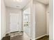 Inviting entryway features hardwood floors, a white front door, and a view into the brightly lit living area at 26857 E Maple Ave, Aurora, CO 80018