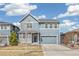 Beautiful two-story home with blue exterior, well-maintained lawn, and attached two-car garage at 26857 E Maple Ave, Aurora, CO 80018