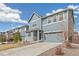 Charming two-story home with blue siding, white trim, brick accents, and a well-manicured lawn at 26857 E Maple Ave, Aurora, CO 80018