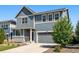 Charming two-story home with blue siding, gray accents, a well-maintained lawn and low maintenance landscaping at 26857 E Maple Ave, Aurora, CO 80018