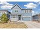 Charming two-story home with blue siding, white trim, brick accents, and a well-manicured lawn at 26857 E Maple Ave, Aurora, CO 80018