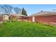 Green backyard featuring a home with a sunroom and a brick garage at 500 S Decatur St, Denver, CO 80219