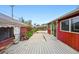 A spacious backyard featuring a home with a sunroom and a brick garage at 500 S Decatur St, Denver, CO 80219
