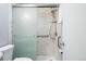 Bathroom featuring a shower with a sliding door and white marble tile at 500 S Decatur St, Denver, CO 80219