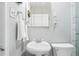 Bathroom with a pedestal sink, toilet, and a mirrored medicine cabinet at 500 S Decatur St, Denver, CO 80219