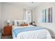 Bedroom featuring a queen-sized bed, natural light, and tasteful decor at 500 S Decatur St, Denver, CO 80219