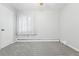 Bedroom with plush carpeting, white walls, and a large window at 500 S Decatur St, Denver, CO 80219