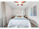 Cozy bedroom featuring plush carpeting, a ceiling fan, and natural light from a window at 500 S Decatur St, Denver, CO 80219