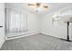 Empty bedroom with plush carpeting, white walls, and a ceiling fan at 500 S Decatur St, Denver, CO 80219
