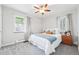 Comfortable bedroom with a queen bed, ceiling fan, and bright natural light at 500 S Decatur St, Denver, CO 80219