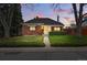 Charming brick home featuring a well-manicured lawn and inviting curb appeal at dusk at 500 S Decatur St, Denver, CO 80219
