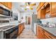 Well-equipped kitchen with wood cabinets, newer appliances, and connection to dining and living areas at 500 S Decatur St, Denver, CO 80219