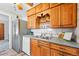 Well-lit kitchen featuring stainless steel fridge and warm-toned wood cabinetry at 500 S Decatur St, Denver, CO 80219