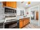 Efficient kitchen with stainless appliances, a passthrough window, and ample counter space at 500 S Decatur St, Denver, CO 80219