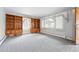 Bright living room featuring built-in shelving and large windows at 500 S Decatur St, Denver, CO 80219