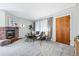 Cozy living room featuring a brick fireplace, modern furnishings, and soft natural light at 500 S Decatur St, Denver, CO 80219