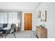 Bright living room showcasing neutral walls, gray carpet, and a dark wood front door at 500 S Decatur St, Denver, CO 80219