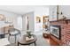 Open living area with a brick fireplace, stylish furniture, and seamless flow to dining area at 500 S Decatur St, Denver, CO 80219