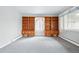 Bright living room featuring built-in shelving and large windows at 500 S Decatur St, Denver, CO 80219