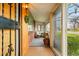 Inviting enclosed front porch with tile flooring, natural light, and cozy seating area at 500 S Decatur St, Denver, CO 80219