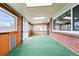 Bright sun room featuring wood paneled walls, brick accents and sliding glass doors to an outdoor patio at 500 S Decatur St, Denver, CO 80219