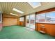 Inviting sunroom featuring skylights, wood paneling, and sliding doors to the backyard at 500 S Decatur St, Denver, CO 80219