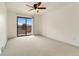 Spacious bedroom featuring a large window and a ceiling fan at 8100 W Quincy Ave # A8, Littleton, CO 80123