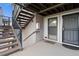 Exterior entrance to unit with wood stairs, gray paint and visible door to a second home at 8100 W Quincy Ave # A8, Littleton, CO 80123