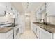 Efficient kitchen design with white cabinets, appliances, and view through to the hallway to the right at 8100 W Quincy Ave # A8, Littleton, CO 80123