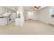 Neutral living room featuring white walls, carpeted floors and a connecting opening to the kitchen at 8100 W Quincy Ave # A8, Littleton, CO 80123