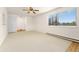 Sunlit living space with neutral carpet, ceiling fan, and views to outside and parquet-style floor at 8100 W Quincy Ave # A8, Littleton, CO 80123