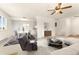 Staged open-plan living space featuring a dining set and comfortable lounge furniture under ceiling fan at 8100 W Quincy Ave # A8, Littleton, CO 80123