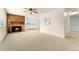 Empty lounge featuring fireplace, ample space, views and neutral-tone walls, floor and ceiling fan at 8100 W Quincy Ave # A8, Littleton, CO 80123