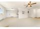 Open-plan living area featuring neutral walls and floor, with doorway to the kitchen and outside views at 8100 W Quincy Ave # A8, Littleton, CO 80123