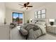 Stylishly furnished bedroom features a ceiling fan, neutral decor and a balcony with views at 8100 W Quincy Ave # A8, Littleton, CO 80123