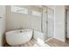 Bright bathroom showcasing a luxurious freestanding tub and a glass-enclosed shower at 1457 Brookfield Pl, Lafayette, CO 80026