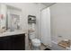 This bathroom has a vanity, toilet, and tiled shower/tub combo with a white shower curtain at 15446 Coopers Hawk Way, Parker, CO 80134