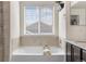 Luxurious bathtub with natural light at 15446 Coopers Hawk Way, Parker, CO 80134