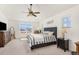 Comfortable bedroom with natural light and ceiling fan at 15446 Coopers Hawk Way, Parker, CO 80134