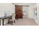 Study room with dark brown desk, designer chair and a gorgeous brown sliding barn door in the background at 15446 Coopers Hawk Way, Parker, CO 80134